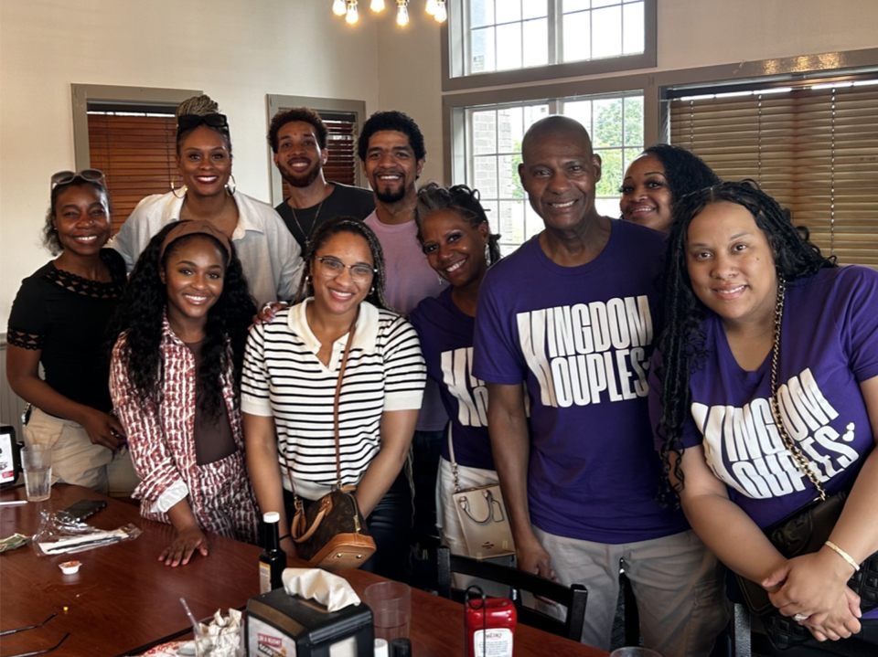 Kingdom Kouples Ministries couples gathered around a restaurant table in Houston, several in purple Kingdom Kouples shirts